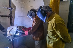 photo of person welding